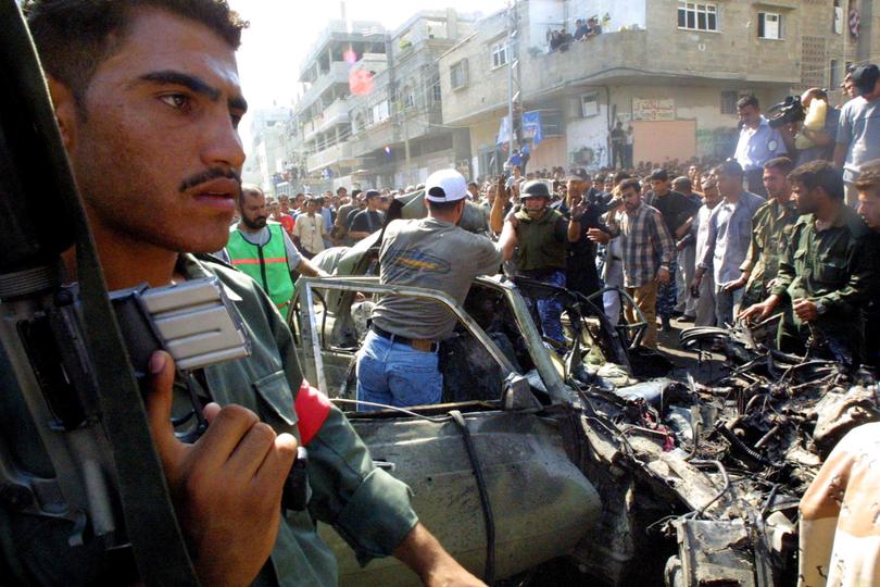 GAZA CITY, GAZA STRIP - SEPTEMBER 26:  Palestinians inspect the wreckage of Hamas bomb expert, Mohammed Deif's car, after it was fired on by Israeli helicopter missiles September 26, 2002 in Gaza City, Gaza Strip. At least two people were killed and 35 others were wounded, including 15 children. Israel said that the target was Deif, and there were conflicting reports about whether he was killed.  (Photo by Abid Katib/Getty Images) 