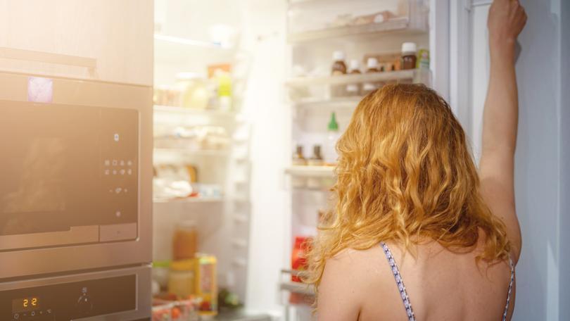 woman in front of the refrigerator