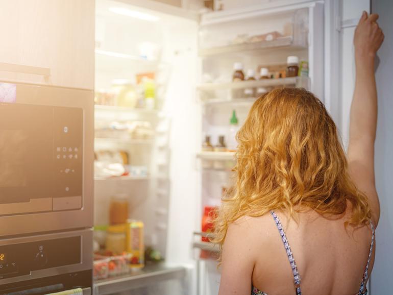 woman in front of the refrigerator