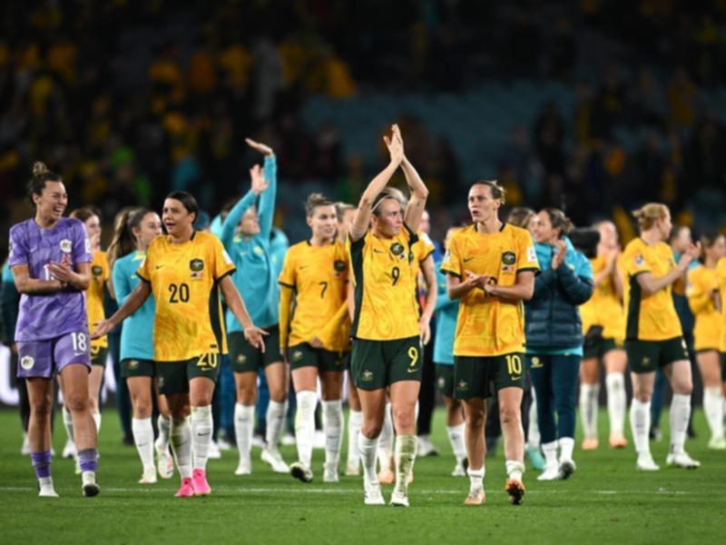 Australia's players celebrate after beating Denmark in the World Cup.
