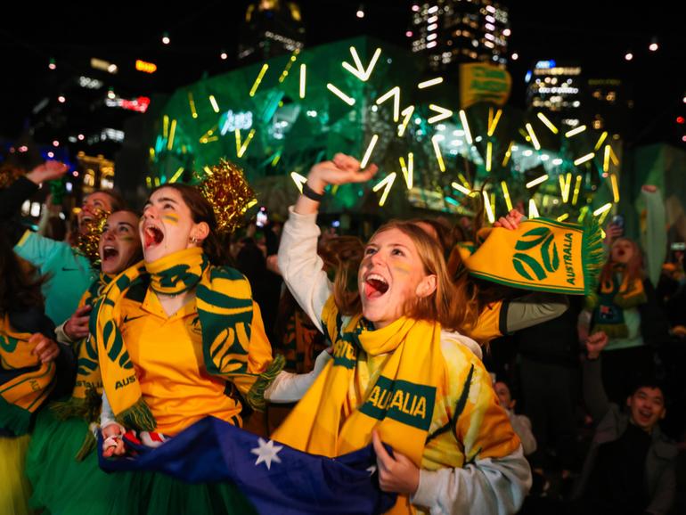 MELBOURNE, AUSTRALIA - AUGUST 07: Australian fans celebrate at Melbourne's Federation Square after watching the Matildas FIFA World Cup win their round of 16 match against Denmark, being played in Sydney, on August 07, 2023 in Melbourne, Australia. (Photo by Asanka Ratnayake/Getty Images) Asanka Ratnayake