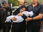 A woman cradles her son, eight-month-old Muhammad Bilal Abu Salah, as residents collect the bodies of Palestinians killed in reported Israeli air strikes on October 28, 2023 in Khan Yunis, Gaza. 