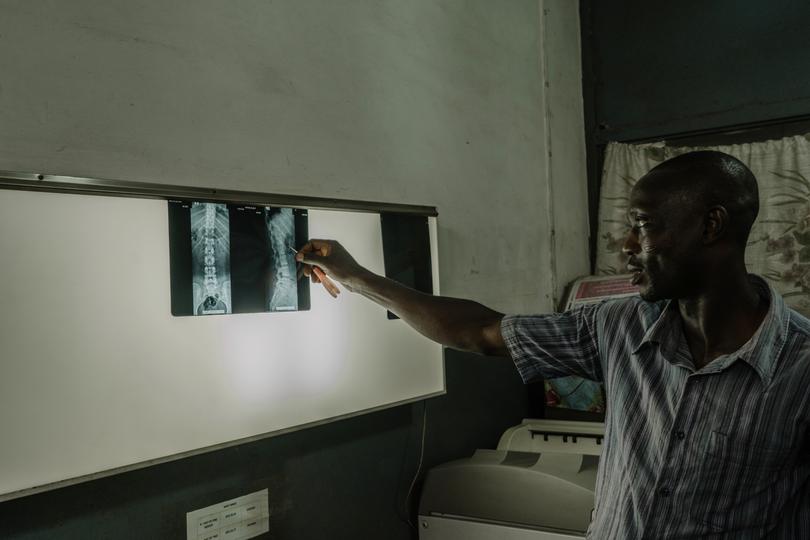 Richard Wonu, a radiographer, interprets a patient’s scans at the Kaneshie Polyclinic in Accra, Ghana, Oct. 24, 2023.  Tuberculosis, which is preventable and curable, has reclaimed the title of the world’s leading infectious disease killer, after being supplanted from its long reign by COVID-19. (Natalija Gormalova/The New York Times)