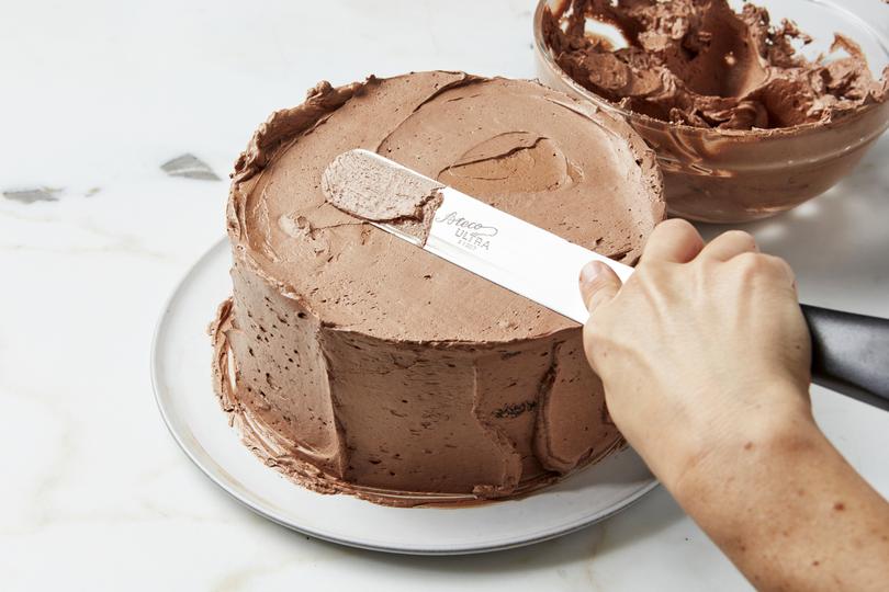 Chocolate layer cake. Melted chocolate gives the frosting its sheen and silky texture. Food styled by Laurie Ellen Pellicano. (Joseph De Leo/The New York Times)