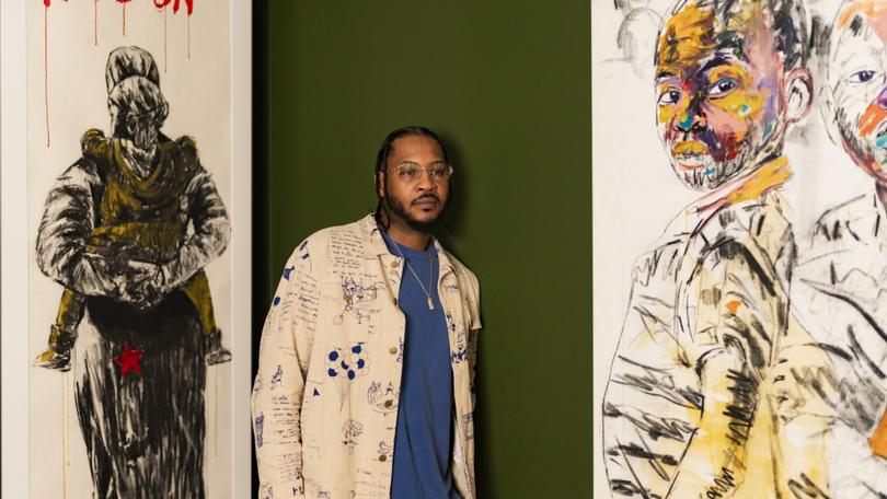Former NBA player Carmelo Anthony near the artwork of Nelson Makamo at his home in Westchester, New York, on Oct. 27, 2023. 