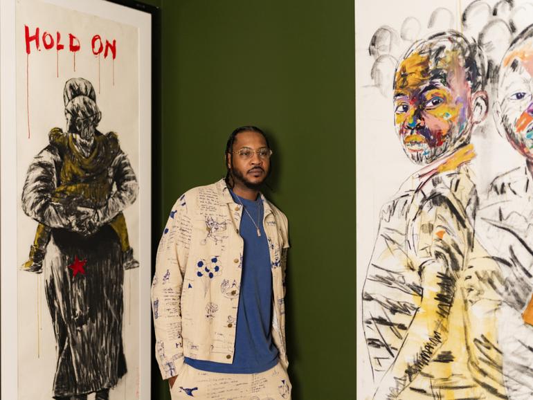 Former NBA player Carmelo Anthony near the artwork of Nelson Makamo at his home in Westchester, New York, on Oct. 27, 2023. 
