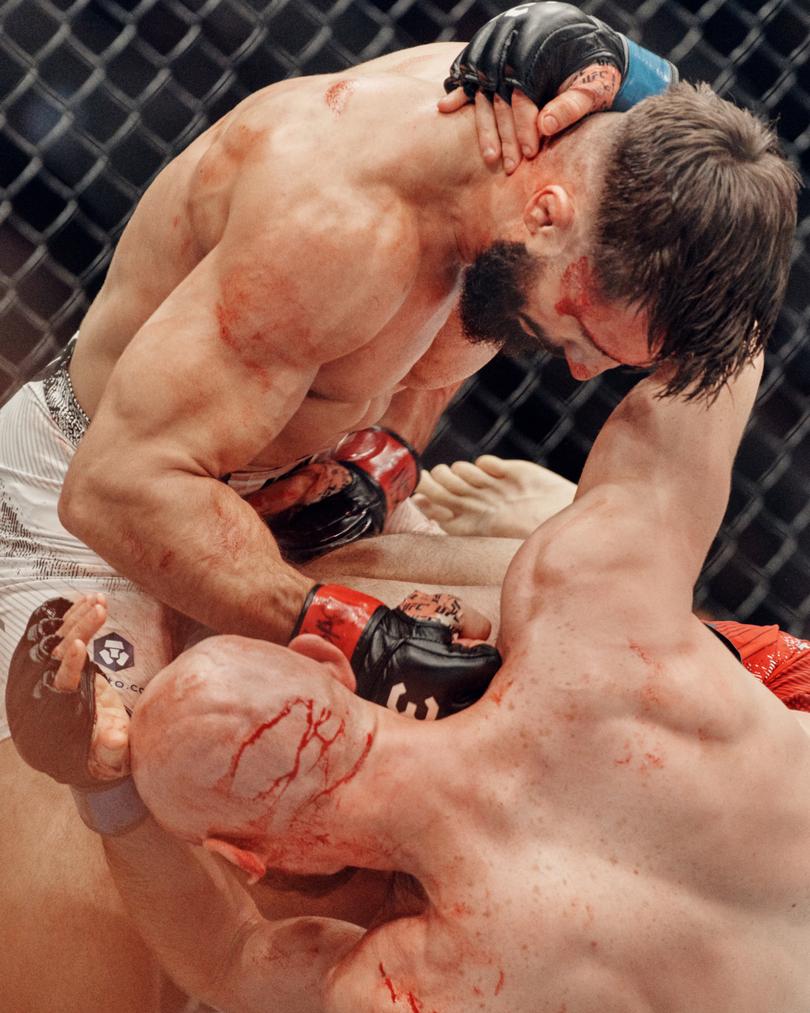 Nazim Sadykhov, top, and Viacheslav Borshchev grapple during UFC 295 at Madison Square Garden in New York, one of Ultimate Fighting Championship’s most important annual events, Nov. 11, 2023. The organization’s announcer Bruce Buffer, known for his baritone growl and ability to fire up the crowd with his “It’s time!” catchphrase, crouches, twists and spins in the caged octagon, has seen his status balloon as the UFC evolved from a ragtag fighting league into a corporate behemoth. (Thomas Prior/The New York Times)