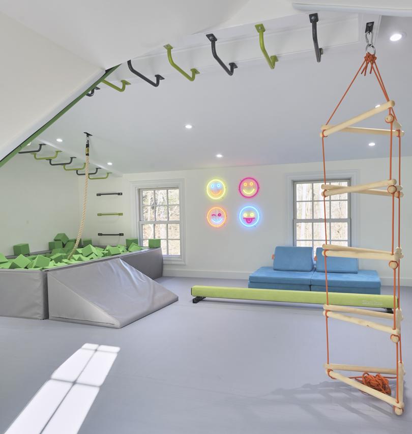 A space by the company Smart Playrooms, which often builds spaces that focus on helping children develop gross motor skills with monkey bars, climbing holds and foam pits. 