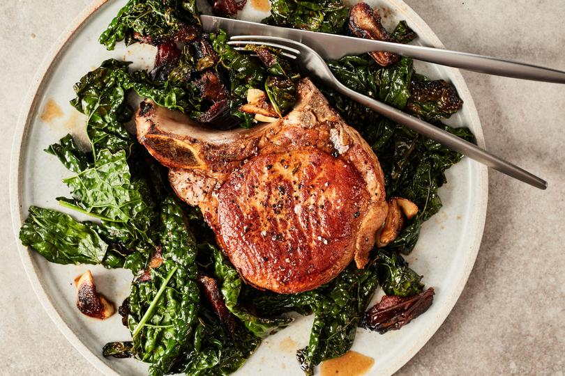 Pork chops with kale and dates. This dinner for two from Ali Slagle feels as special as a restaurant dish but comes together in one pan in half an hour. Food styled by Cybelle Tondu. (Johnny Miller/The New York Times)