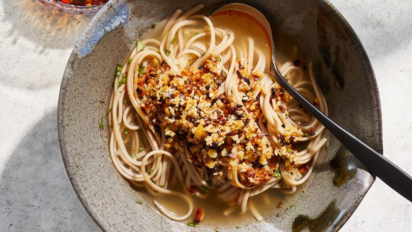 Soba noodles with ginger broth and crunchy ginger. If you still need to finish off the last of your turkey, enjoy it with this soothing noodle soup from Yotam Ottolenghi. Props styled by Paige Hicks. Food styled by Simon Andrews. (Christopher Simpson/The New York Times)