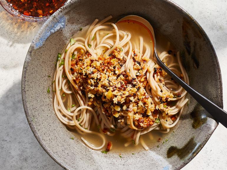 Soba noodles with ginger broth and crunchy ginger. If you still need to finish off the last of your turkey, enjoy it with this soothing noodle soup from Yotam Ottolenghi. Props styled by Paige Hicks. Food styled by Simon Andrews. (Christopher Simpson/The New York Times)