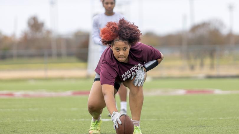 Honesty Butler snaps the ball during flag football practice at Fort Scott Community College.

