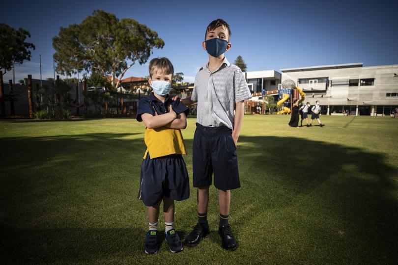 Edward (6) and Oscar Harrison (10) at Christ Church Grammar School. First day back at school during COVID 2022.