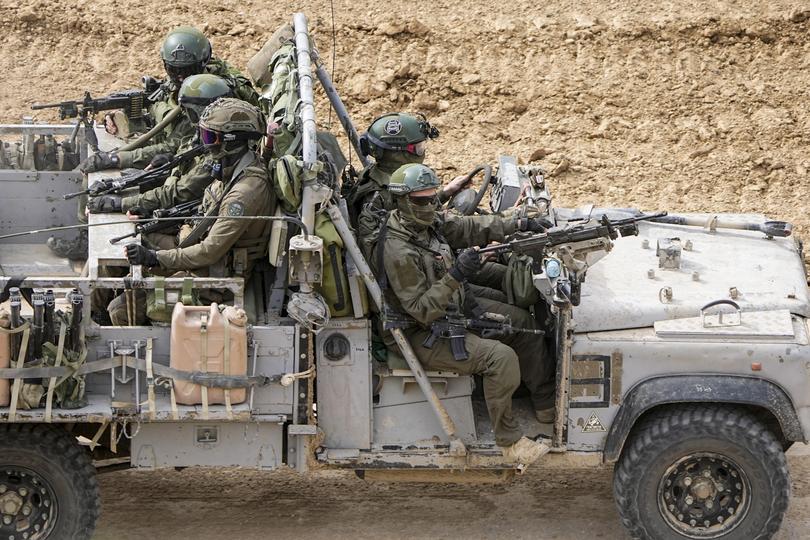 Israeli soldiers drive towards the Gaza Strip, in southern Israel, Tuesday, Feb. 13, 2024. The army is battling Palestinian militants across Gaza in the war ignited by Hamas' Oct. 7 attack into Israel. (AP Photo/Ariel Schalit)