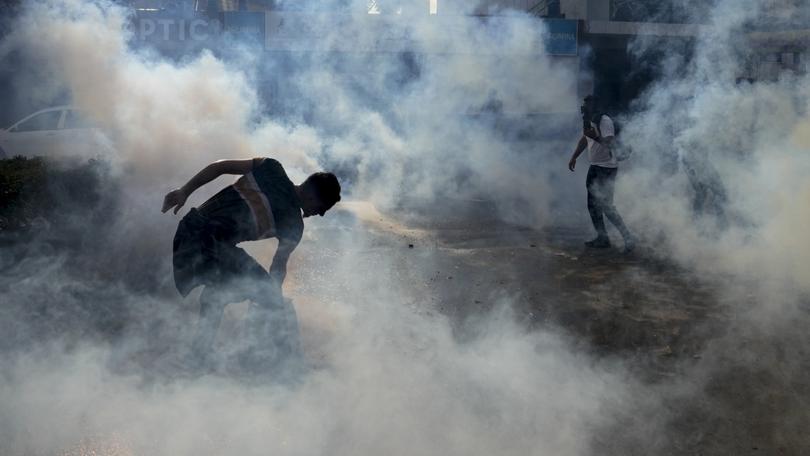 Riot police use tear gas against protesters during a demonstration, in solidarity with the Palestinian people, in Lebanon.