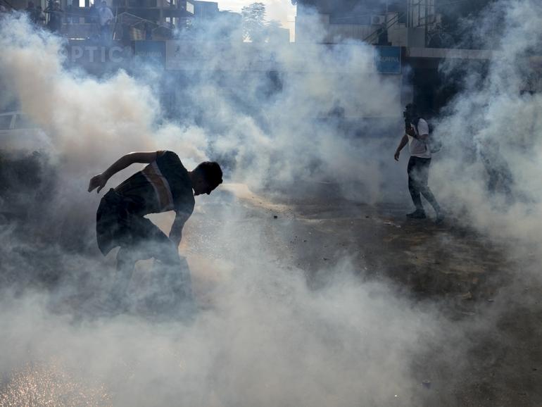 Riot police use tear gas against protesters during a demonstration, in solidarity with the Palestinian people, in Lebanon.