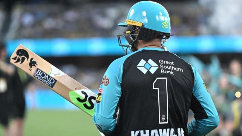 A symbol of peace is visible as Usman Khawaja goes out to bat for the Brisbane Heat against Perth. 