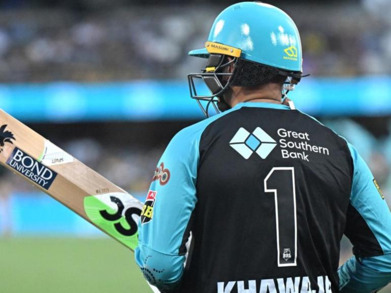A symbol of peace is visible as Usman Khawaja goes out to bat for the Brisbane Heat against Perth. 
