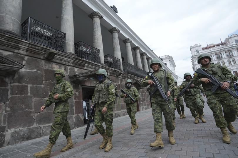 Soldiers patrol outside the government palace during a state of emergency in Quito, Ecuador, Tuesday, Jan. 9, 2024. The country has seen a series of attacks after the government imposed a state of emergency in the wake of the apparent escape of a powerful gang leader from prison. (AP Photo/Dolores Ochoa)