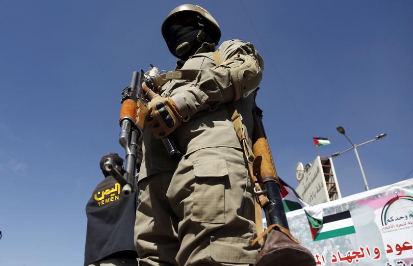 SANAA, YEMEN - JANUARY 11: A military personnel stands guard at the area as people gather to stage a protest against United Nations (UN) Security Council resolution demands that Houthis immediately cease all attacks on ships in Red Sea in Sanaa, Yemen on January 11, 2024. Yemen's Houthi group on Thursday denigrated a UN Security Council resolution demanding the group to halt Red Sea attacks as a "political game." (Photo by Mohammed Hamoud/Anadolu via Getty Images)