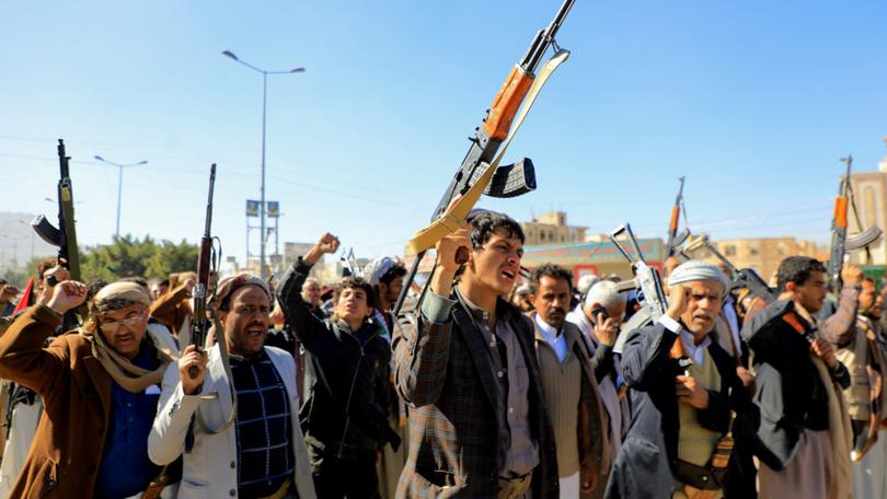 Houthi fighters brandish their weapons during a march in solidarity with the Palestinian people in the Houthi-controlled capital Sanaa on January 11, 2024, 