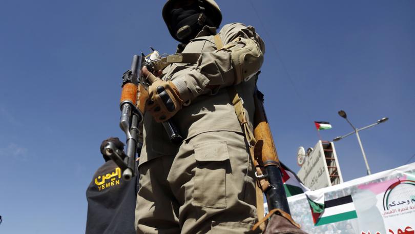 A military personnel stands guard at the area as people gather to stage a protest against United Nations (UN) Security Council.