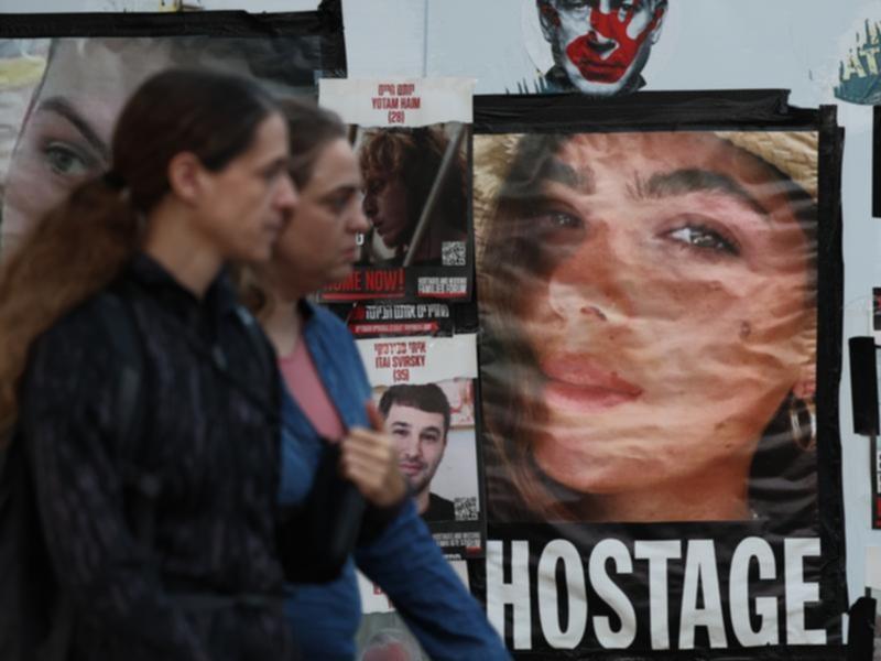 Posters showing images of the hostages held by Hamas in Gaza