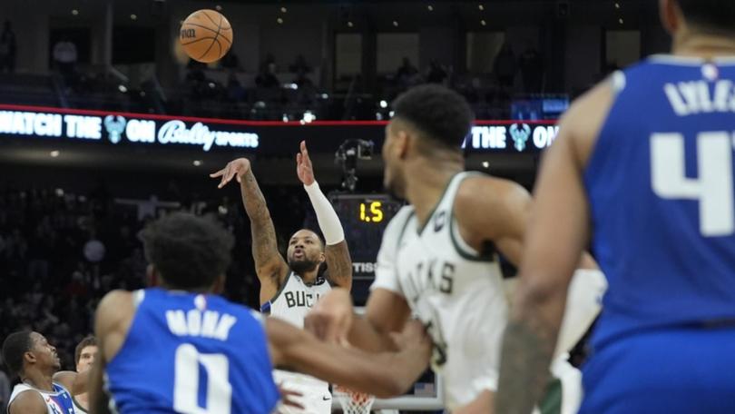 Damian Lillard puts up the game-winning 3-pointer during overtime for Milwaukee against Sacramento. (AP PHOTO)