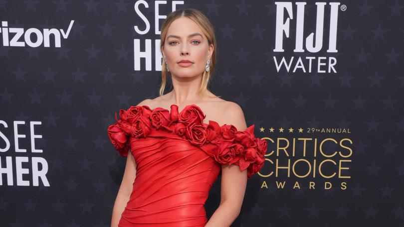 Margot Robbie ditched the colour pink as she strutted her stuff of the red carpet.