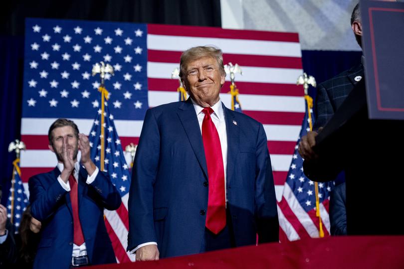 Republican presidential candidate former President Donald Trump appears at a caucus night party in Des Moines, Iowa, Monday, Jan. 15, 2024. Also pictured is Eric Trump, left. (AP Photo/Andrew Harnik)