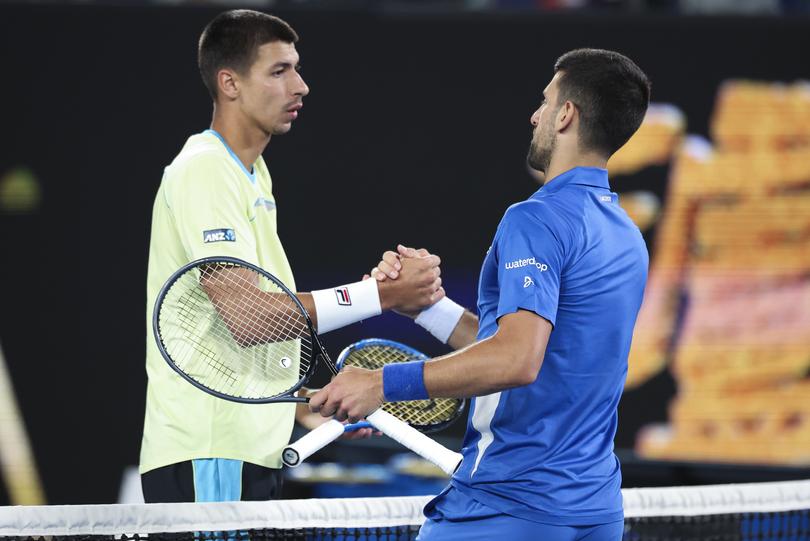 Novak Djokovic, right, of Serbia is congratulated by Alexei Popyrin of Australia following their second round match at the Australian Open tennis championships at Melbourne Park, Melbourne, Australia, Wednesday, Jan. 17, 2024. (AP Photo/Asanka Brendon Ratnayake)