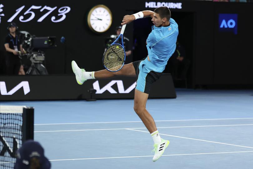 Alexei Popyrin of Australia plays a forehand return to Novak Djokovic of Serbia during their second round match at the Australian Open tennis championships at Melbourne Park, Melbourne, Australia, Wednesday, Jan. 17, 2024. (AP Photo/Asanka Brendon Ratnayake)