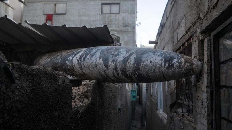 An unexploded Israeli missile lodged between two houses of Al Nusairat refugee camp. (EPA PHOTO)