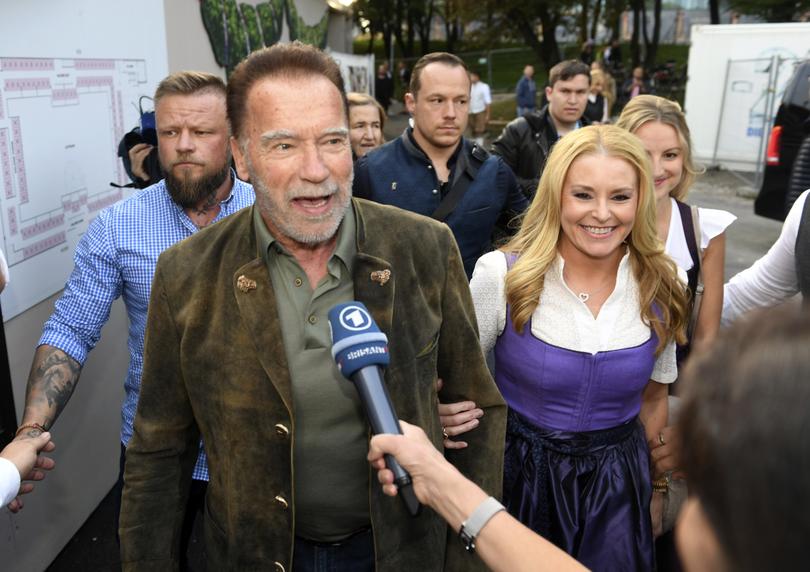 Actor Arnold Schwarzenegger and his girlfriend Heather Milligan go to the Marstall Festival tent in Munich, Germany, Saturday, Sept. 23, 2023. (Felix H'rhager/dpa via AP)