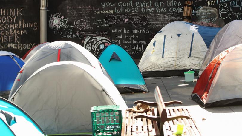 Tents stand in front of a chalkboard wall at a camp for the homeless at Martin Place in Sydney, Australia, on Thursday, Aug. 1, 2017. On the doorstep of Australia's premier economic institution, a camp of about three-dozen tents and a kitchen for the homeless has come to symbolize the housing affordability crisis gripping Sydney, where prices have soared 127 percent since 2009. Photographer: Brendon Thorne/Bloomberg