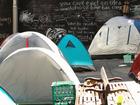 Tents stand in front of a chalkboard wall at a camp for the homeless at Martin Place in Sydney, Australia, on Thursday, Aug. 1, 2017. On the doorstep of Australia's premier economic institution, a camp of about three-dozen tents and a kitchen for the homeless has come to symbolize the housing affordability crisis gripping Sydney, where prices have soared 127 percent since 2009. Photographer: Brendon Thorne/Bloomberg