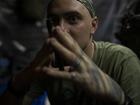 A Ukrainian soldier sits inside a trench on the frontline in the outskirts of Lyman, Ukraine, Tuesday, Aug. 15, 2023.