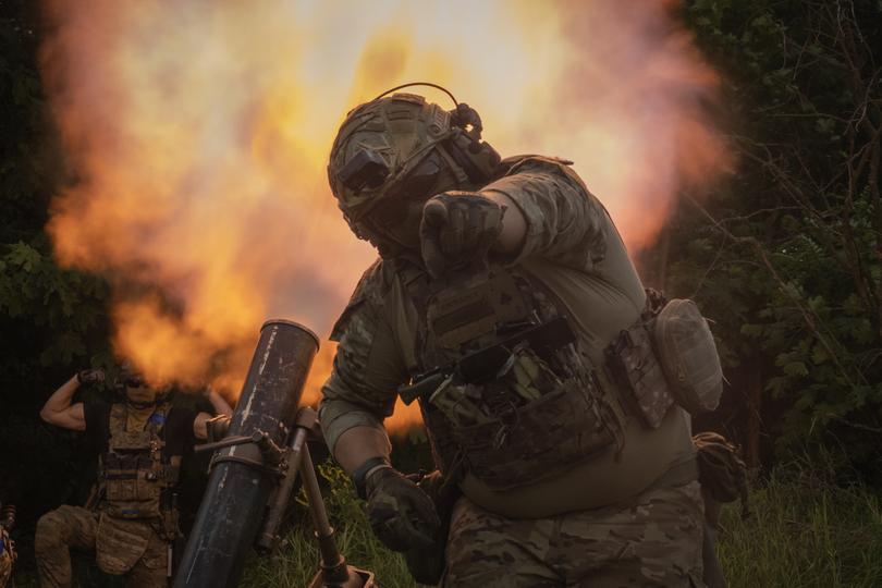 A Ukrainian soldier gestures as he fires toward Russian position on the frontline in Zaporizhzhia region, Ukraine, Saturday, June 24, 2023. (AP Photo/Efrem Lukatsky)