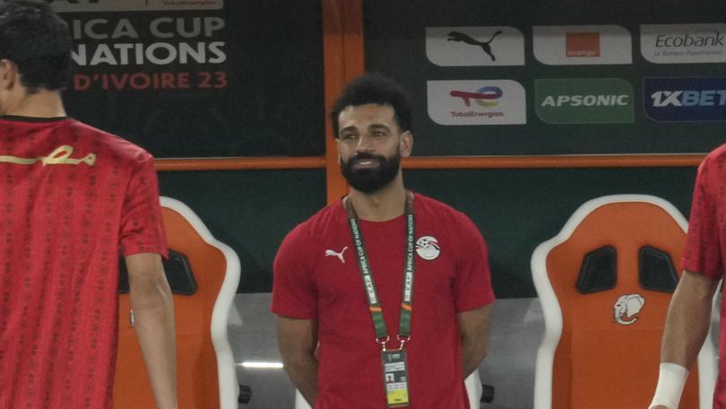 Egypt's injured player Mohamed Salah, centre, watches his team mates warm up before the African Cup of Nations Group B soccer match between Cape Verde and Egypt. (AP Photo/Themba Hadebe)