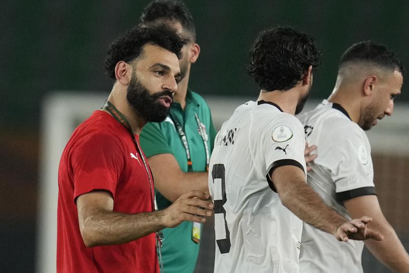 Egypt's Mohamed Salah, left, consoles team players after they conceded a late equaliser during the African Cup of Nations Group B soccer match between Cape Verde and Egypt at the Felix Houphouet Boigny stadium in Abidjan, Ivory Coast, Monday, Jan. 22, 2024. (AP Photo/Themba Hadebe)