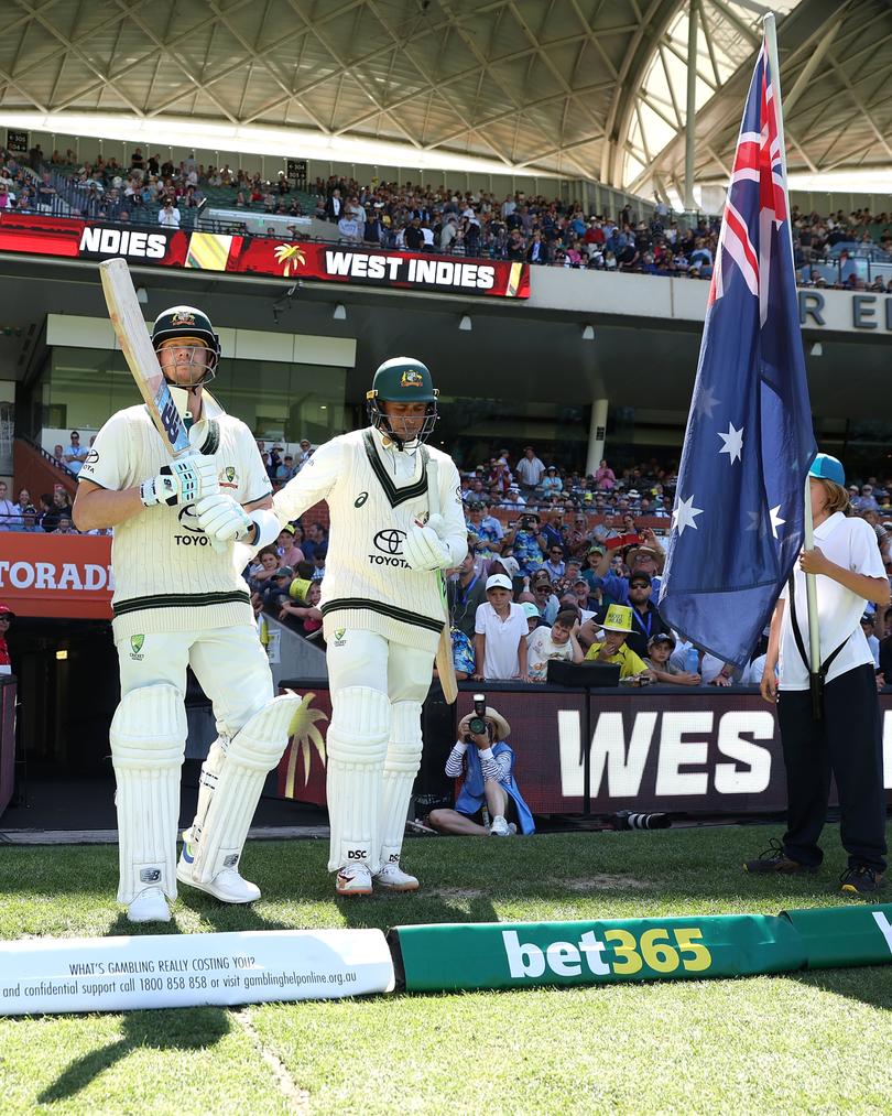 Steve Smith and Usman Khawaja of Australia walk out to open the batting during the Mens Test match series between Australia and West Indies at Adelaide Oval on January 17. (Photo by Paul Kane/Getty Images)