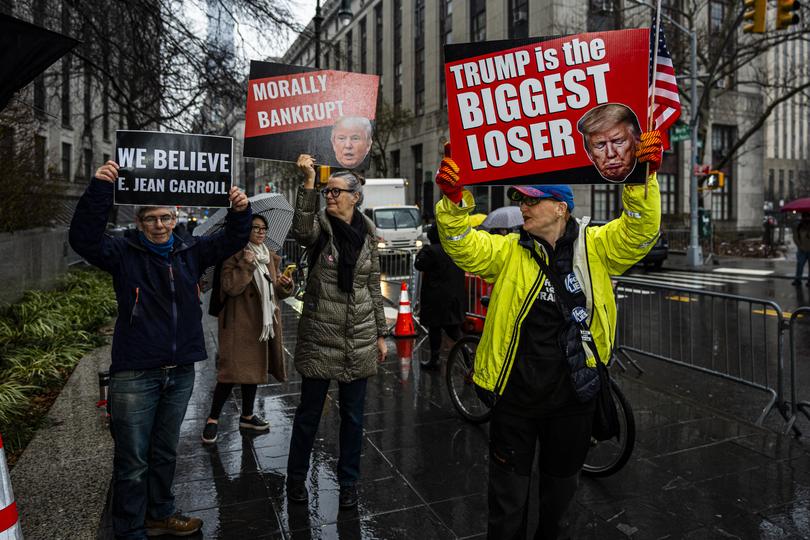 Protestors demonstrate outside Federal Court, Thursday, Jan. 25, 2024, in New York. Former President Donald Trump could return to a New York courtroom Thursday to defend himself against a lawsuit seeking more than $10 million for things he said about advice columnist E. Jean Carroll after she accused him of sexual assault. (AP Photo/Peter K. Afriyie)