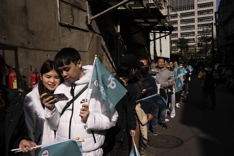 Supporters of Ko Wen-je, Taiwan People's Party (TPP) presidential candidate, wait in line to take photographs with Ko Wen-je in New Taipei City, Taiwan, on Thursday, Jan. 11, 2024. (AP Photo/Louise Delmotte)