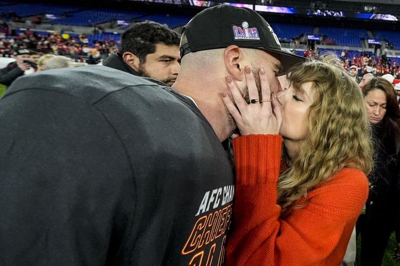 Taylor Swift kisses Kansas City Chiefs tight end Travis Kelce after the Chiefs’ AFC Championship win against the Baltimore Ravens. (AP Photo/Julio Cortez)