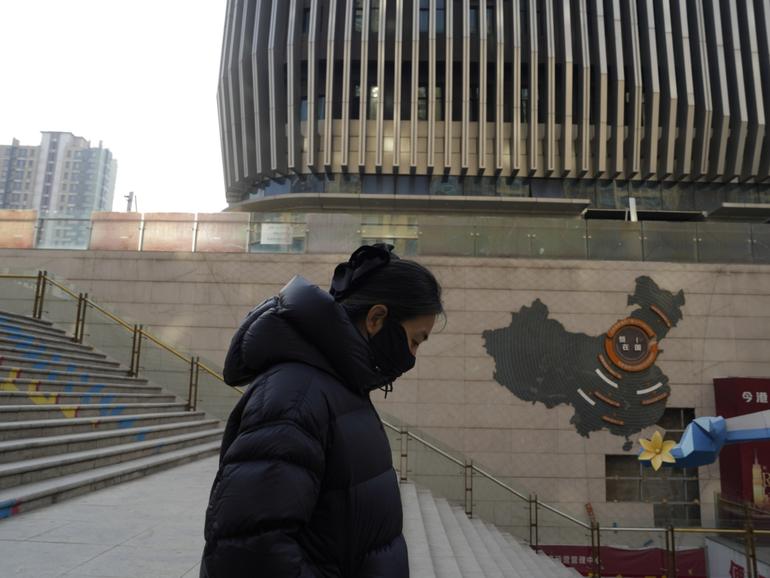 A woman walks through a partially shuttered Evergrande commercial complex in Beijing, Monday, Jan. 29, 2024. Chinese property developer China Evergrande Group on Monday was ordered to liquidate by a Hong Kong court, after the firm was unable to reach a restructuring deal with creditors. (AP Photo/Ng Han Guan)