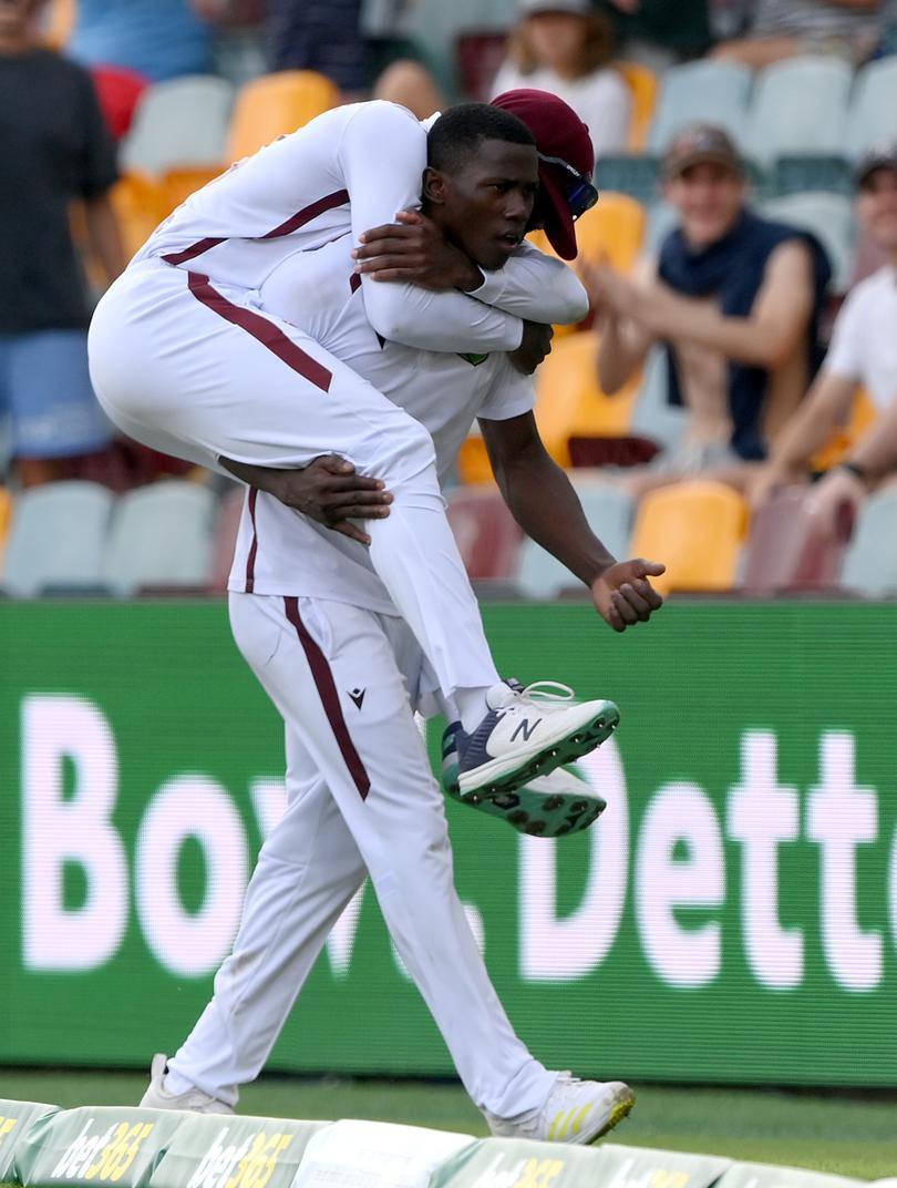 Shamar Joseph of the West Indies celebrates victory after taking the wicket of Josh Hazlewood.