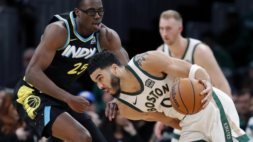 Boston Celtics forward Jayson Tatum (0) drives against Indiana Pacers' Jalen Smith (25) during the second half of an NBA basketball game, Tuesday, Jan. 30, 2024, in Boston. (AP Photo/Michael Dwyer)