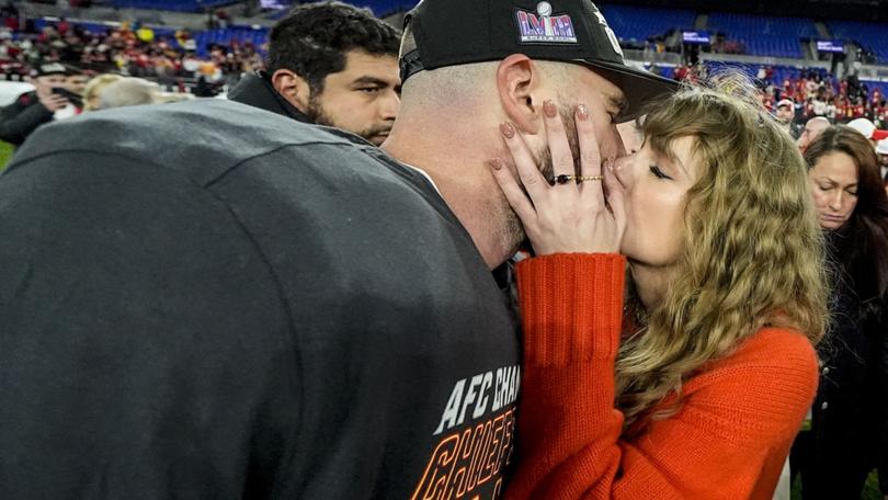 Taylor Swift kisses Kansas City Chiefs tight end Travis Kelce after an AFC Championship NFL football game against the Baltimore Ravens.