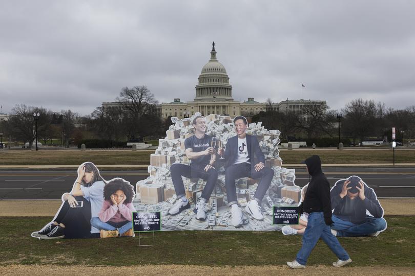 A protest poster depicting Meta CEO Mark Zuckerberg and TikTok CEO Shou Zi Chew on display near the Capitol as they testified along with other social media chief executives before a Senate Judiciary Committee hearing on online child sexual exploitation on Capitol Hill in Washington, Jan. 31, 2024. (Tom Brenner/The New York Times) 