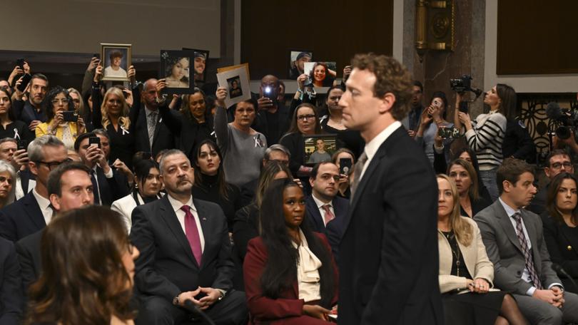 Members of the audience hold up portraits of victims of online abuse as Mark Zuckerberg, chief executive of Meta, addresses the audience during a Senate Judiciary Committee hearing on online child sexual exploitation on Capitol Hill in Washington, Jan. 31, 2024. (Kenny Holston/The New York Times) 